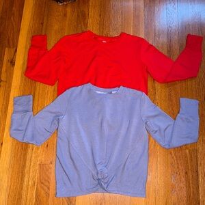 Two Athleta Girl waist length sweatshirt with front twist.